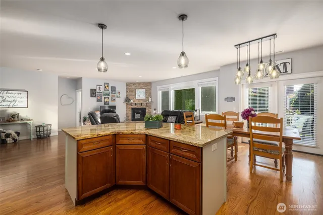 a open kitchen with stainless steel appliances granite countertop a stove and refrigerator