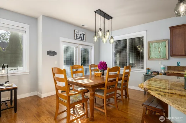a view of a dining room with furniture and a chandelier