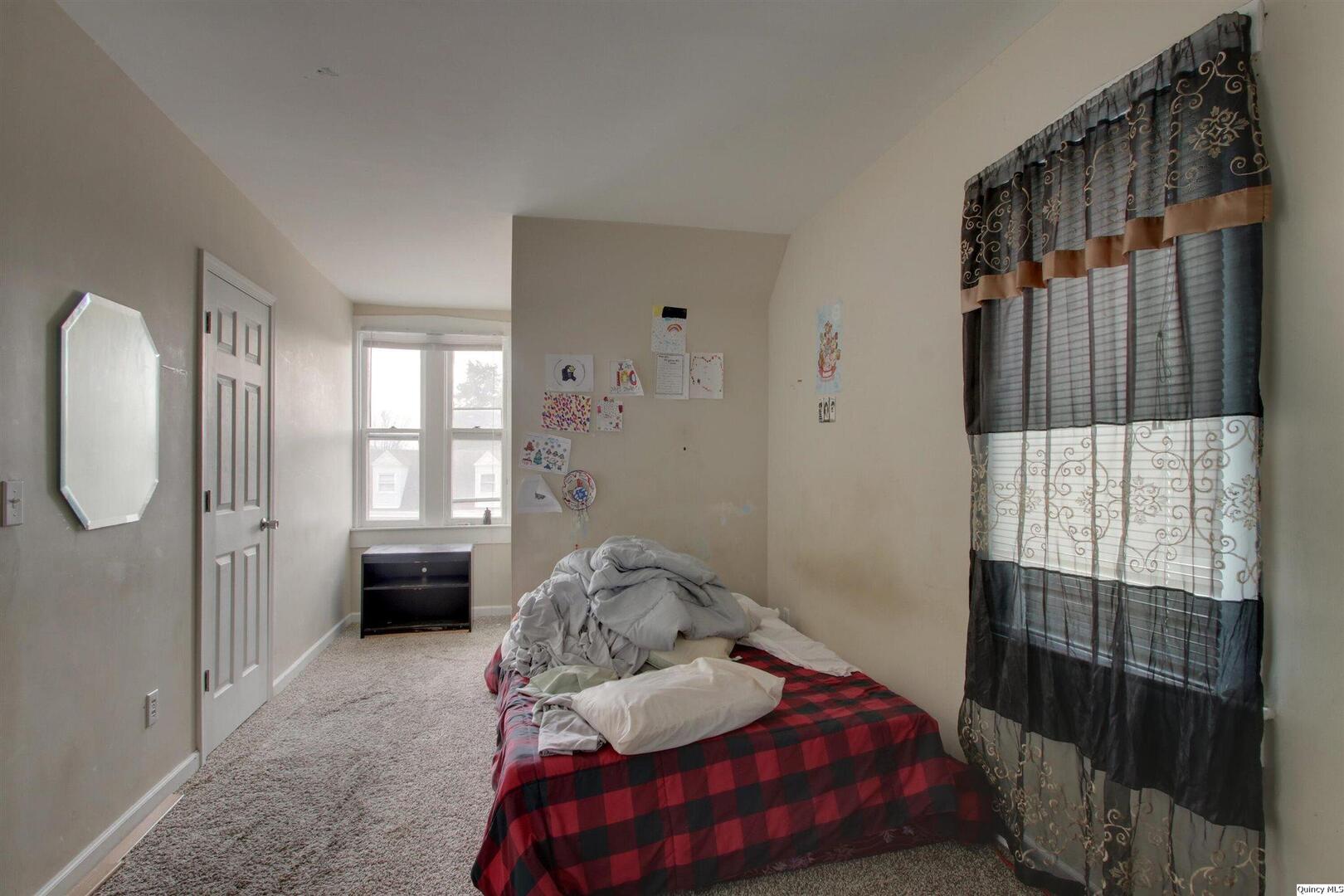 1127 Payson Avenue Quincy, IL 62301 - Photo 11 of 16 a bedroom with a bed and a window