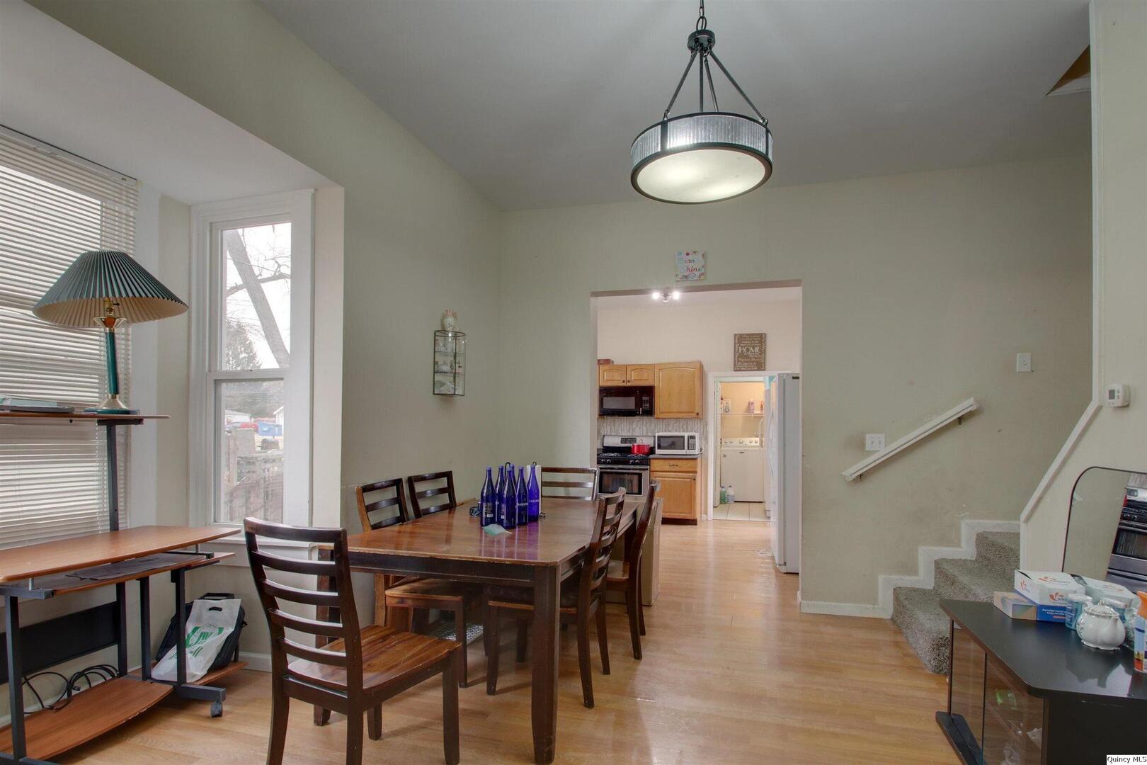 1127 Payson Avenue Quincy, IL 62301 - Photo 12 of 16 a view of a dining room with furniture window and wooden floor