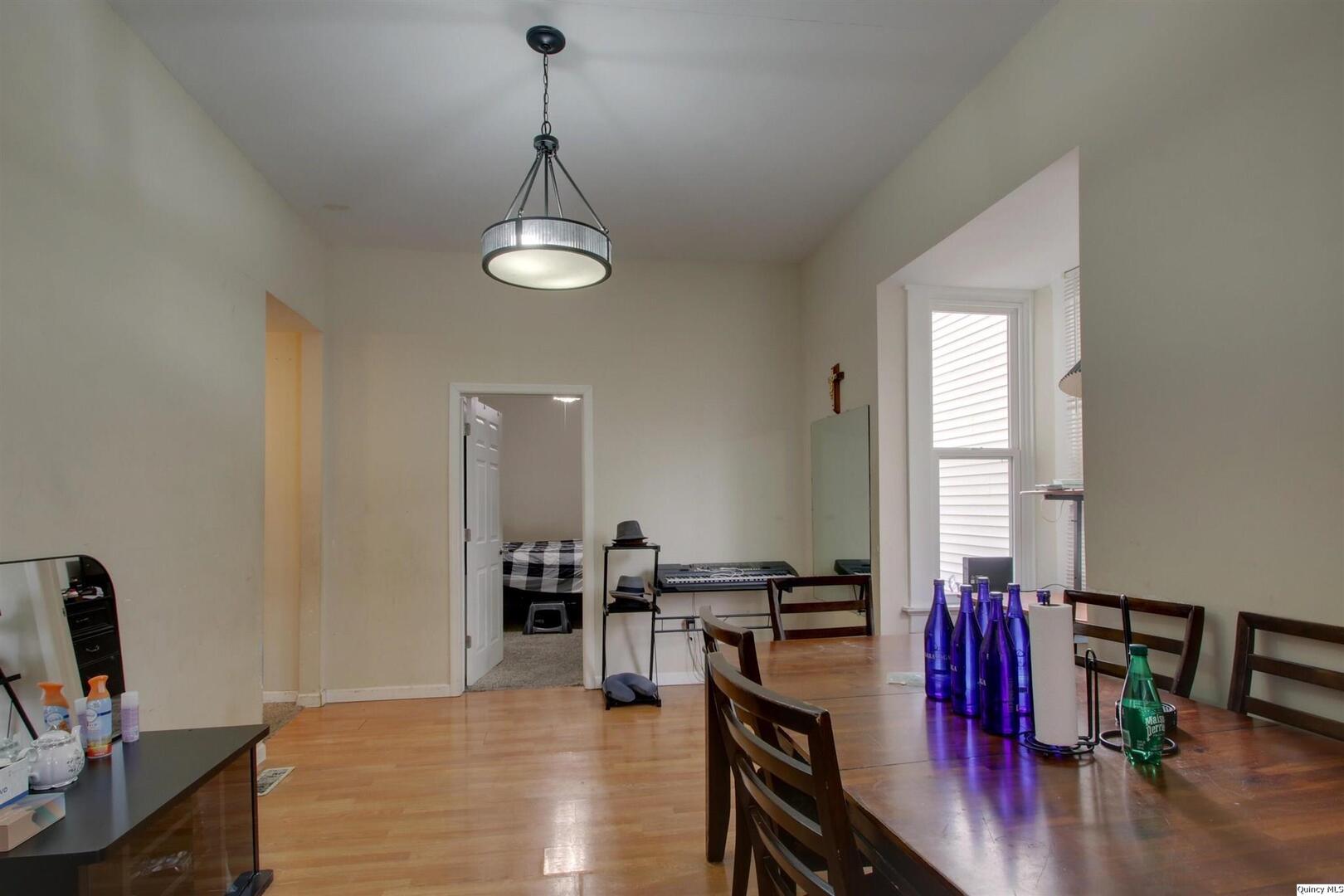 1127 Payson Avenue Quincy, IL 62301 - Photo 13 of 16 a view of a dining room with furniture window and wooden floor