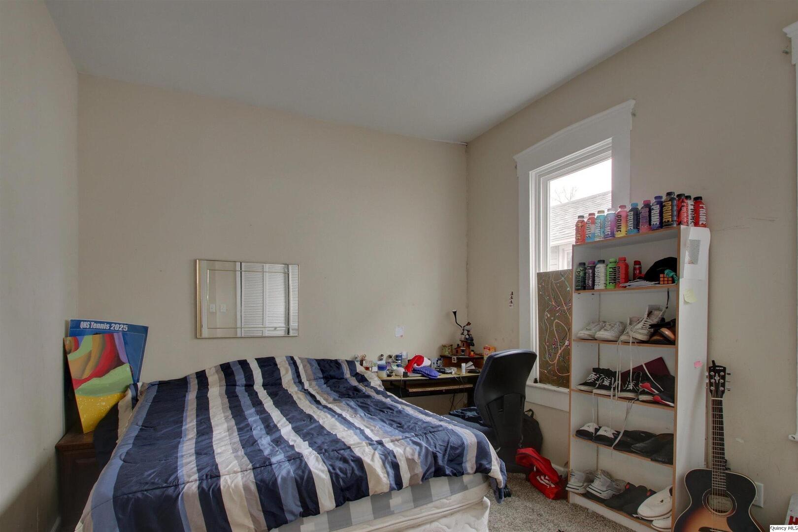 1127 Payson Avenue Quincy, IL 62301 - Photo 14 of 16 a bedroom with a bed and a window