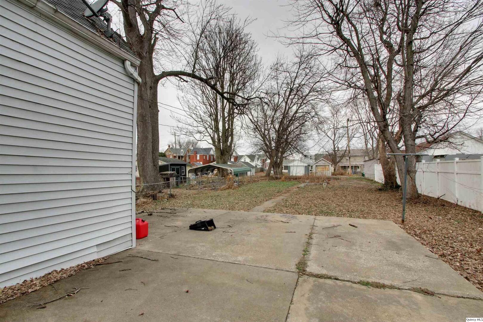 1127 Payson Avenue Quincy, IL 62301 - Photo 2 of 16 a sign board with yard and trees