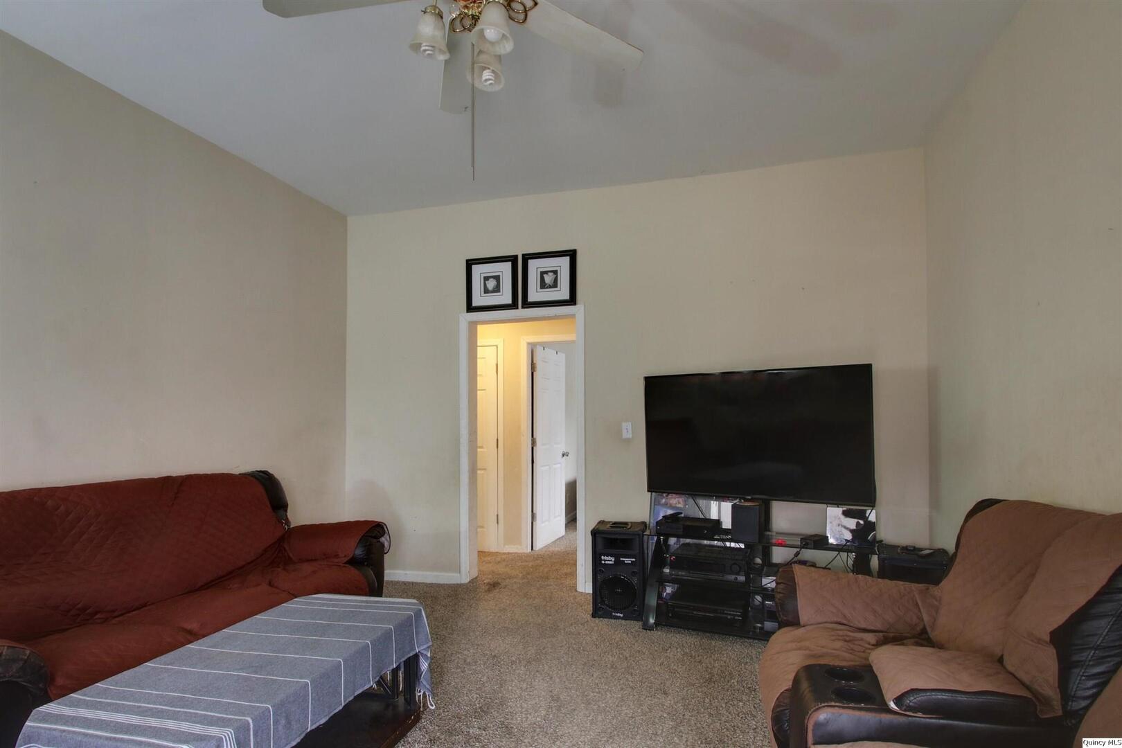 1127 Payson Avenue Quincy, IL 62301 - Photo 5 of 16 a living room with furniture and a flat screen tv