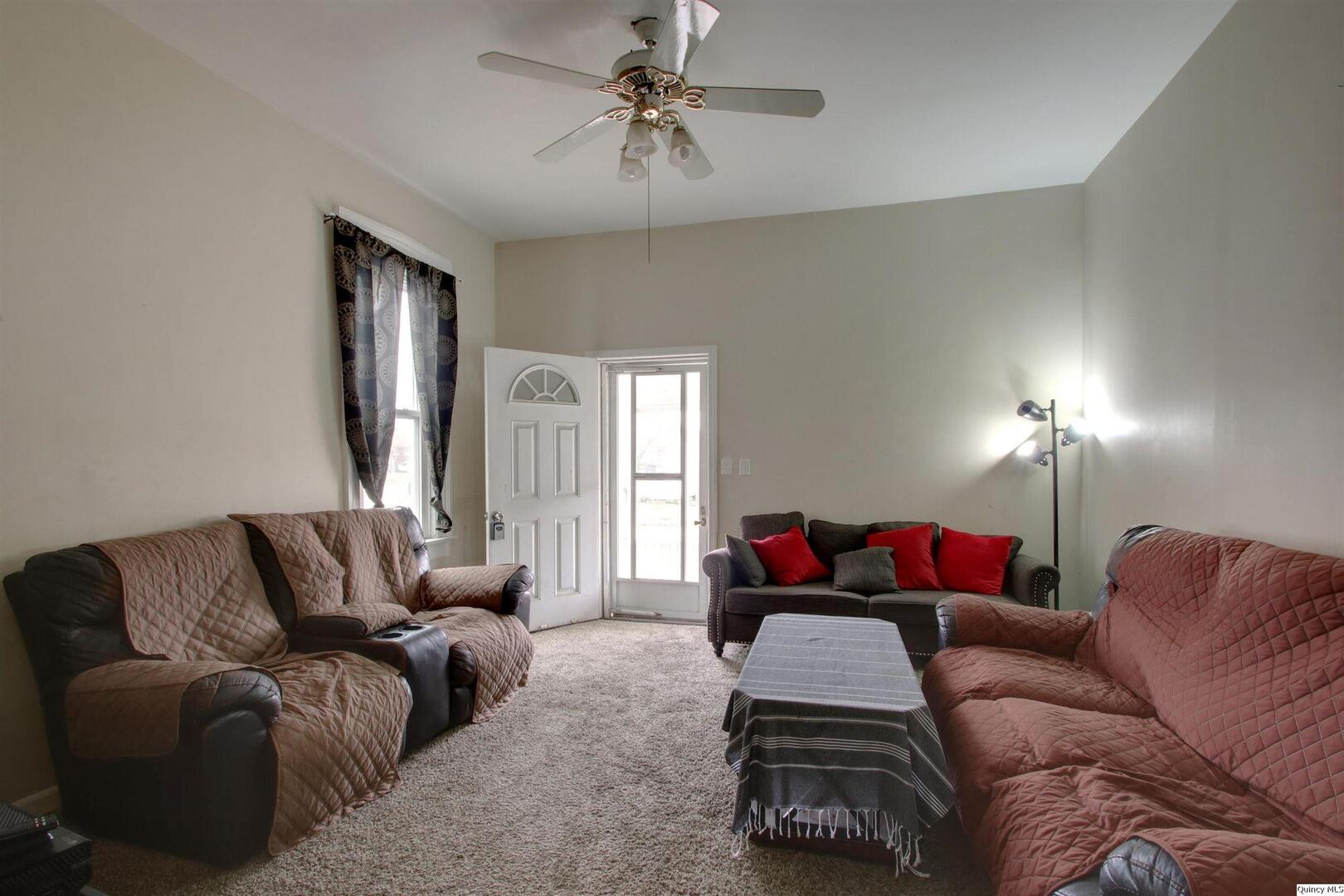 1127 Payson Avenue Quincy, IL 62301 - Photo 7 of 16 a living room with furniture ceiling fan and a window