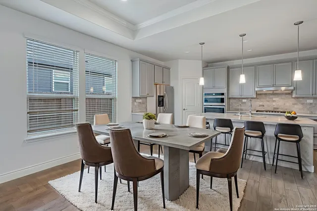 a view of a dining room with furniture and wooden floor