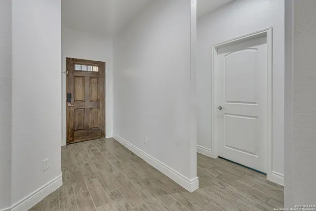 an empty room with wooden floor and closet
