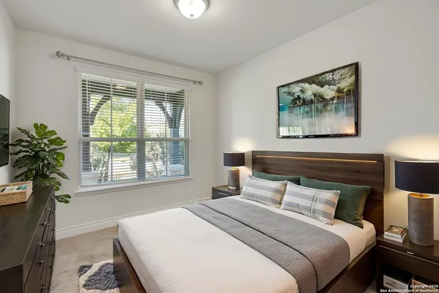 a bedroom with a bed and a painting on the wall