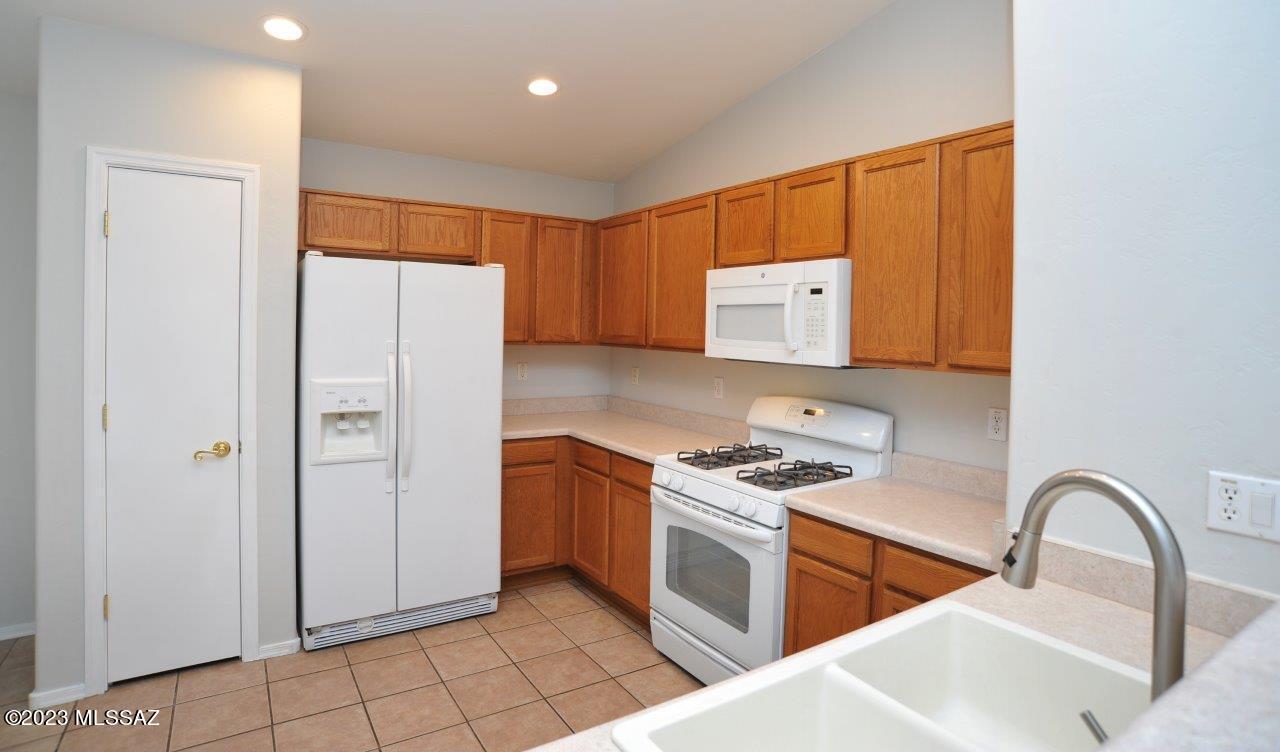 4543 South Valley Road Tucson, AZ 85714 - Photo 17 of 41 a kitchen with stainless steel appliances granite countertop a refrigerator and a stove top oven