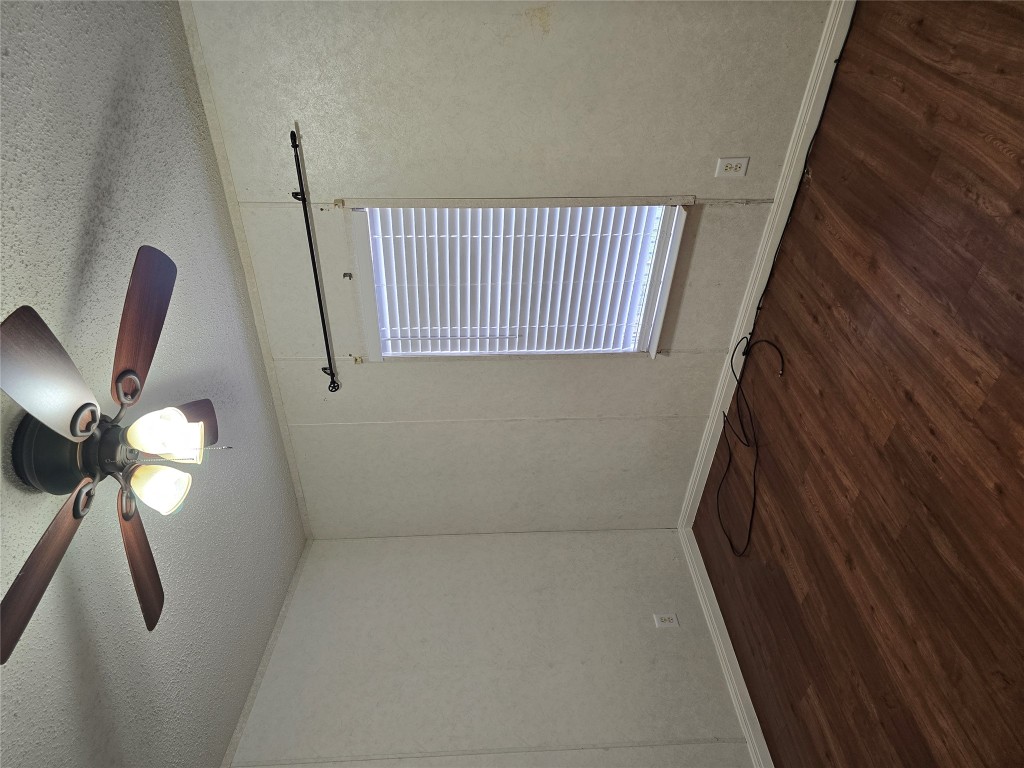 7628 Northview Lane Austin, TX 78724 - Photo 10 of 19 Empty room featuring dark wood-style floors, a textured ceiling, and ceiling fan
