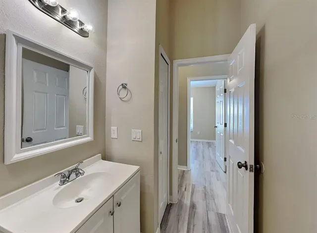 a bathroom with a sink vanity and mirror