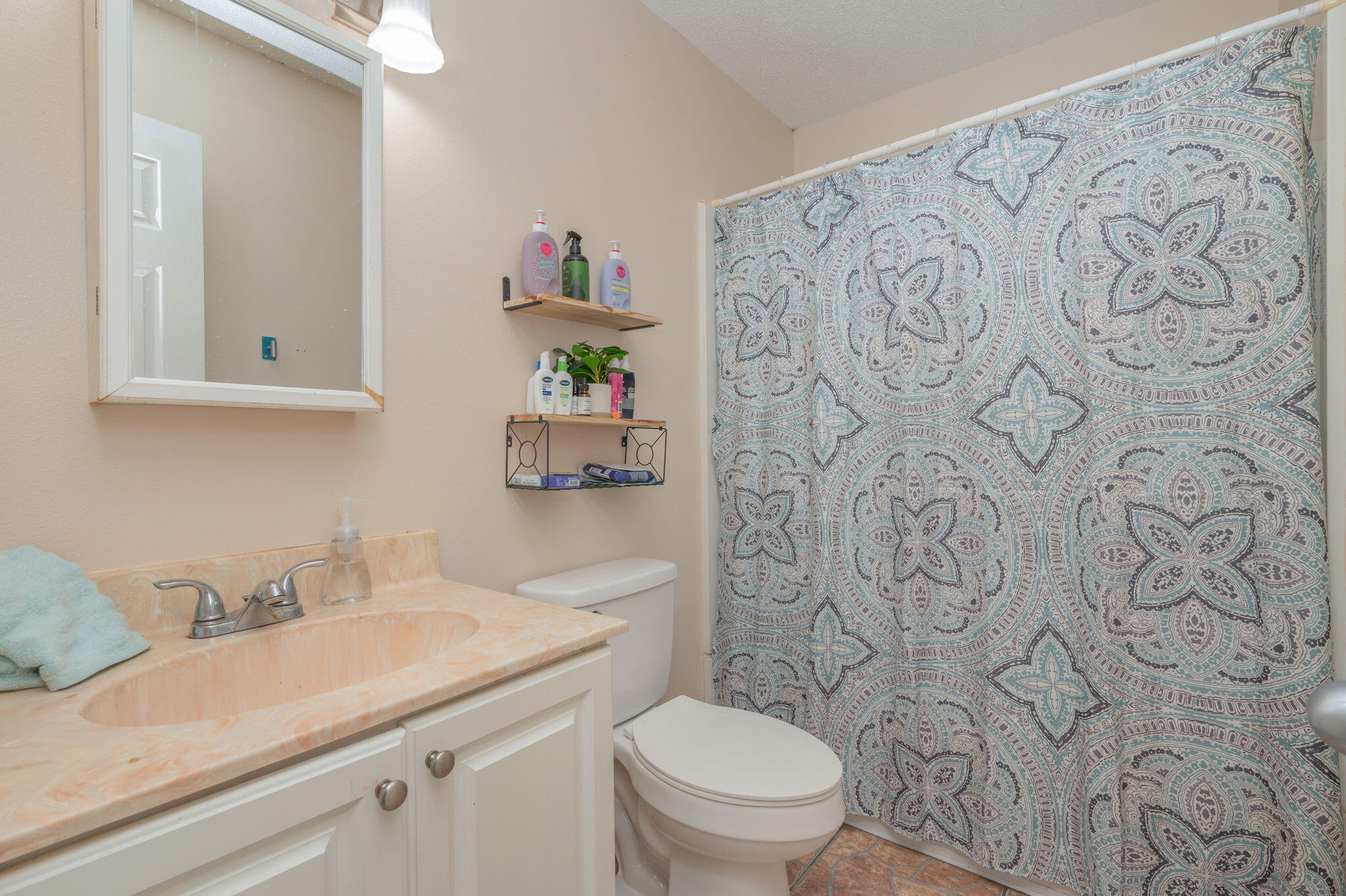 834 McDonald Street Crestview, FL 32536 - Photo 18 of 35 a bathroom with a granite countertop sink and a toilet