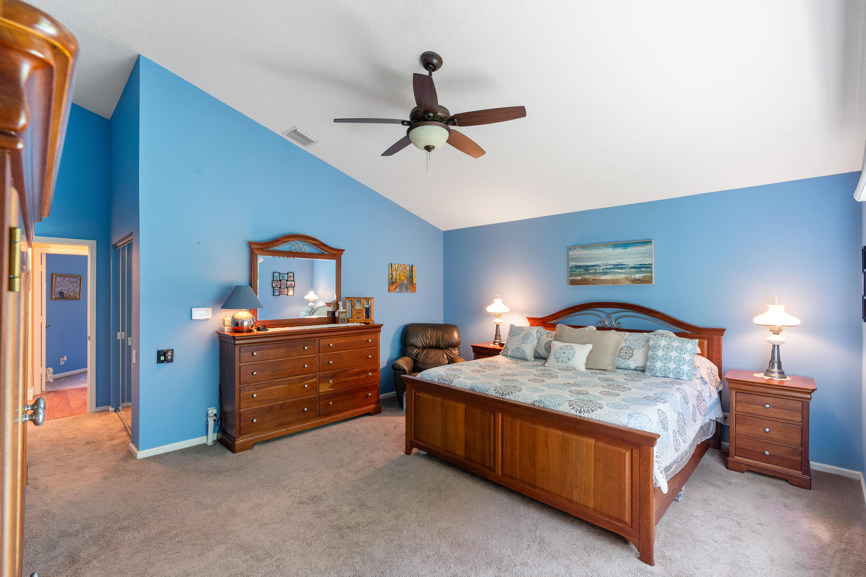 7296 Falls Road East Boynton Beach, FL 33437 - Photo 15 of 25 a bedroom with a bed and a chandelier