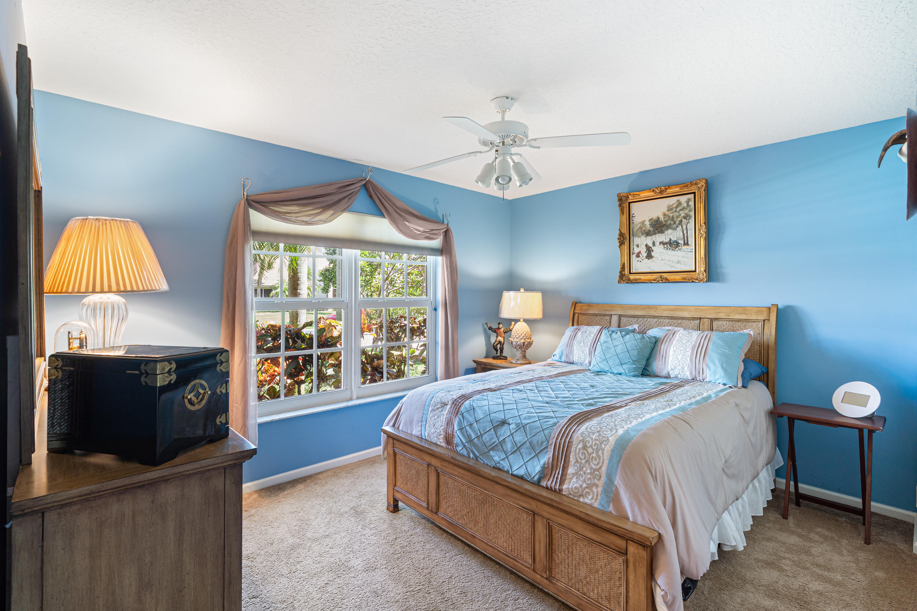 7296 Falls Road East Boynton Beach, FL 33437 - Photo 18 of 25 a bedroom with a bed and a chandelier