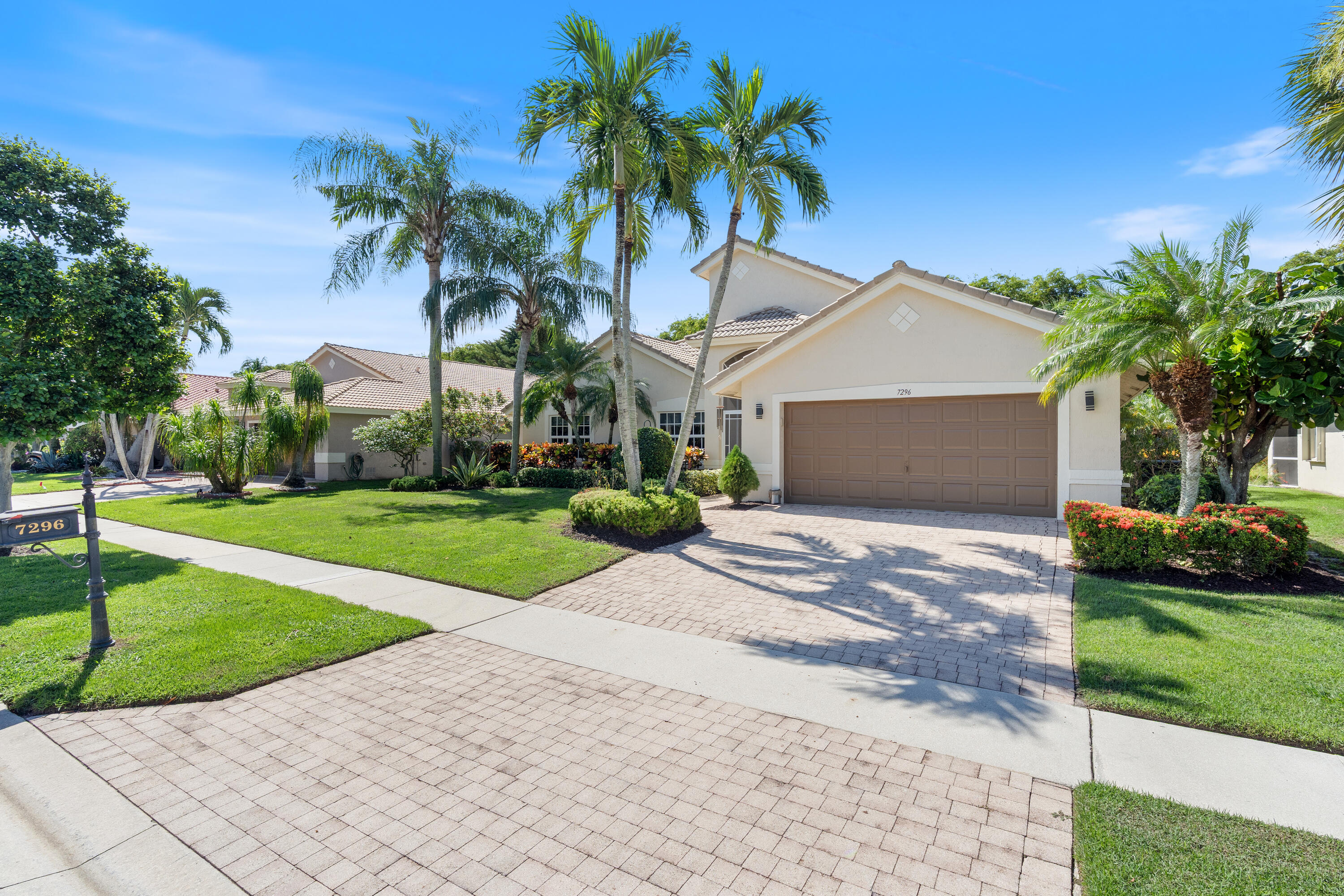 7296 Falls Road East Boynton Beach, FL 33437 - Photo 2 of 25 a front view of house with yard and green space