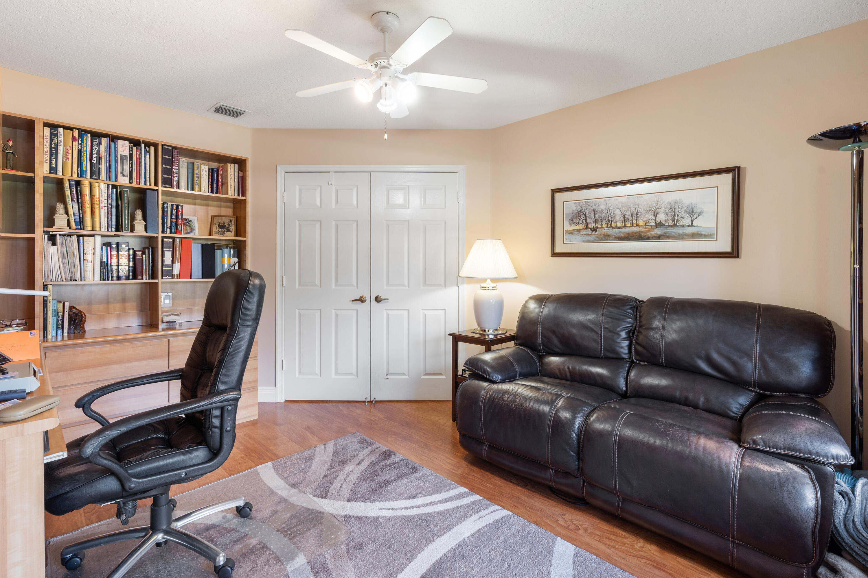 7296 Falls Road East Boynton Beach, FL 33437 - Photo 22 of 25 a living room with furniture a bookshelf and a bookshelf