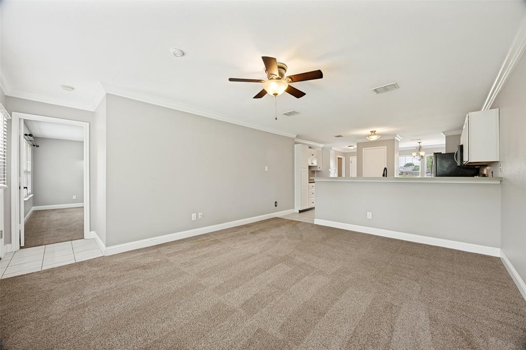 1601 Elm Street Anna, TX 75409 - Photo 9 of 25 a view of a kitchen with an empty space and a ceiling fan