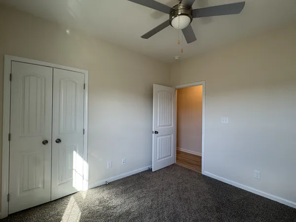 a view of empty room with ceiling fan