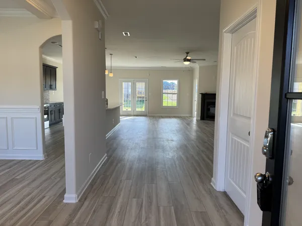 wooden floor in an empty room with a window