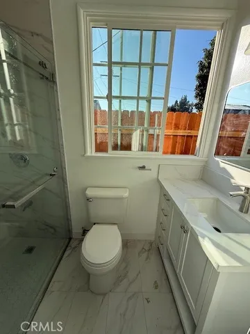 a bathroom with a toilet sink and shower