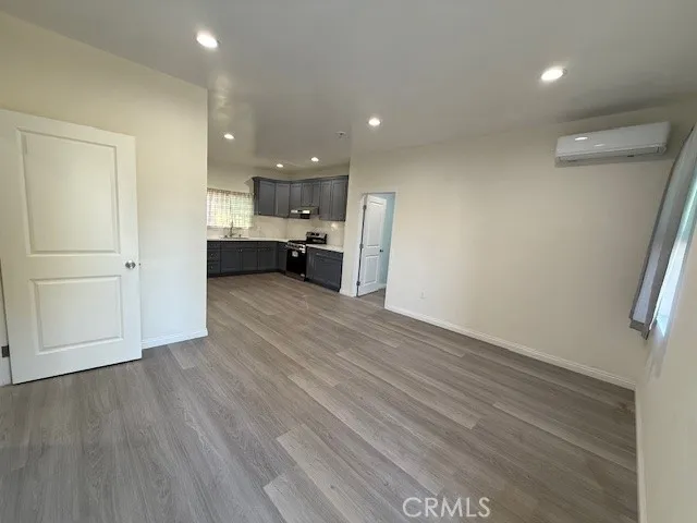 a view of a kitchen with a sink and a refrigerator