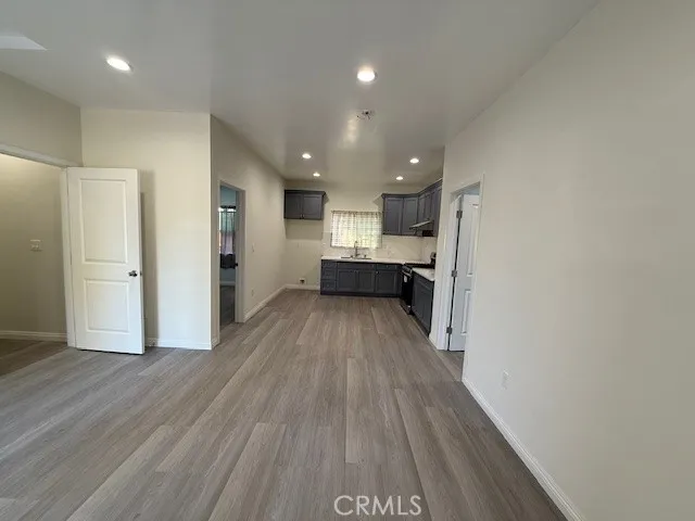 a view of kitchen with wooden floor and electronic appliances