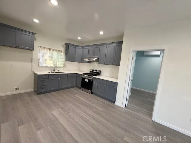 a kitchen with stainless steel appliances granite countertop a sink counter space and cabinets