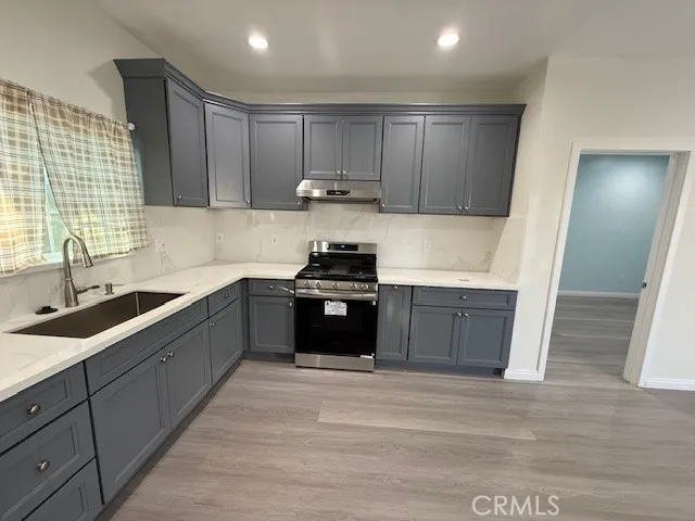 a kitchen with a sink a window and cabinets