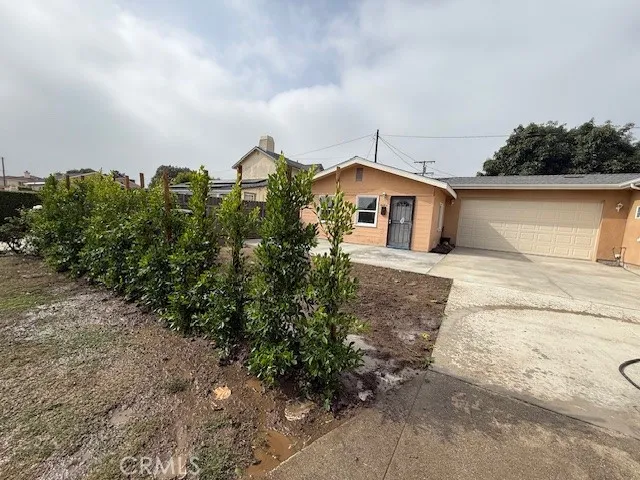 a view of a house with a yard and wooden fence
