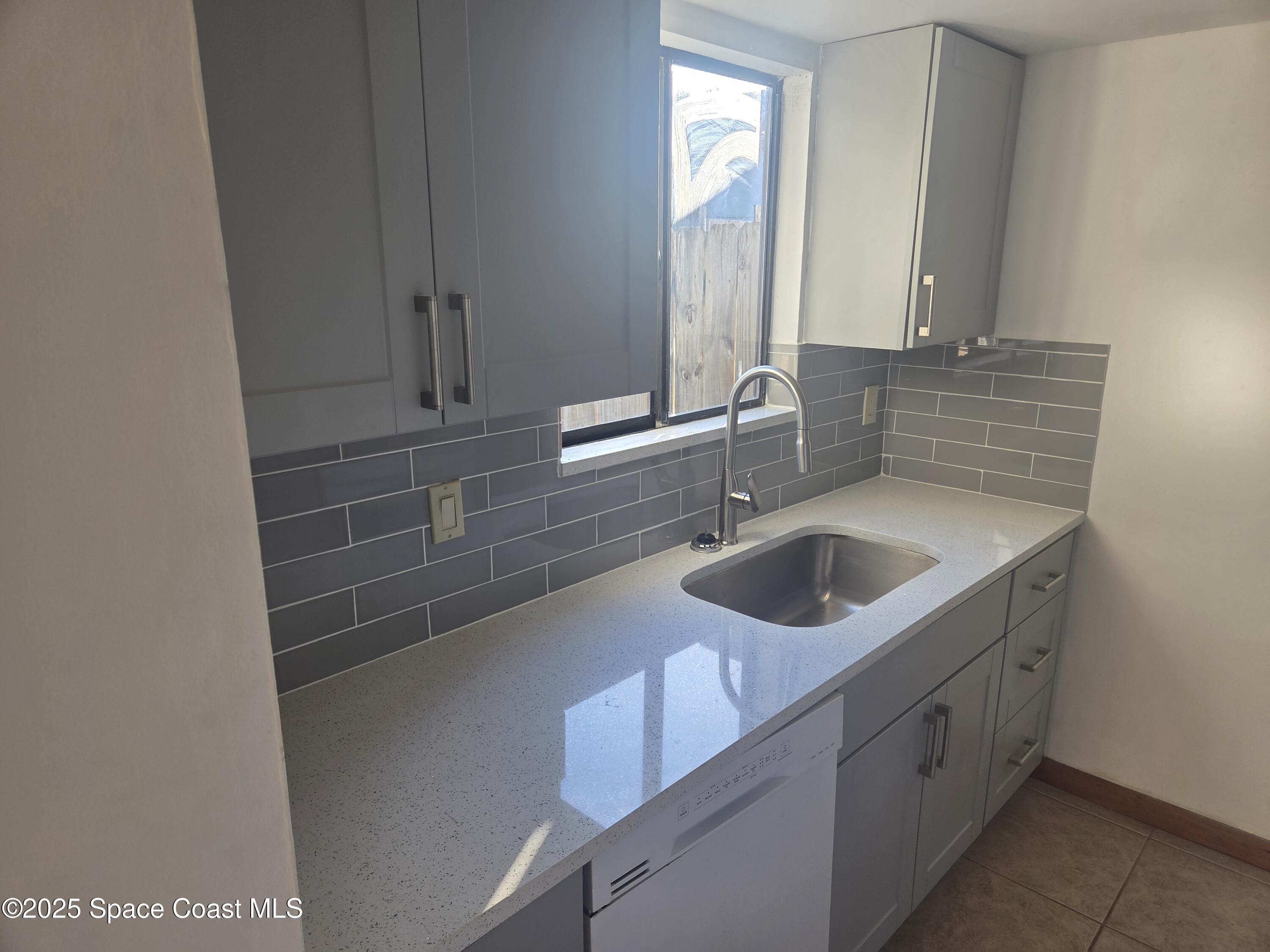 4611 Tree Ridge Lane Northeast Palm Bay, FL 32905 - Photo 2 of 7 a bathroom with a sink and a mirror