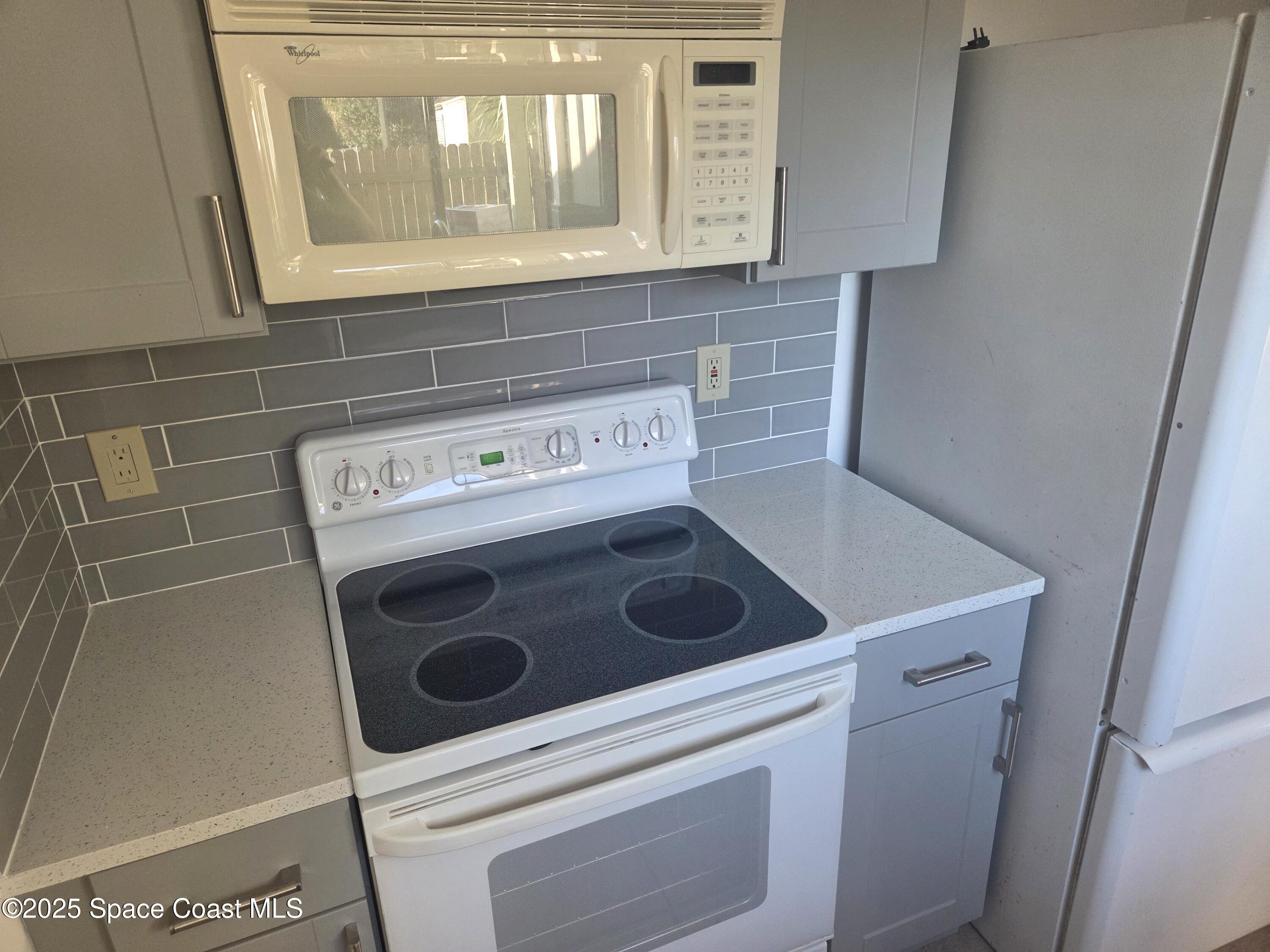 4611 Tree Ridge Lane Northeast Palm Bay, FL 32905 - Photo 3 of 7 a utility room with dryer and washer