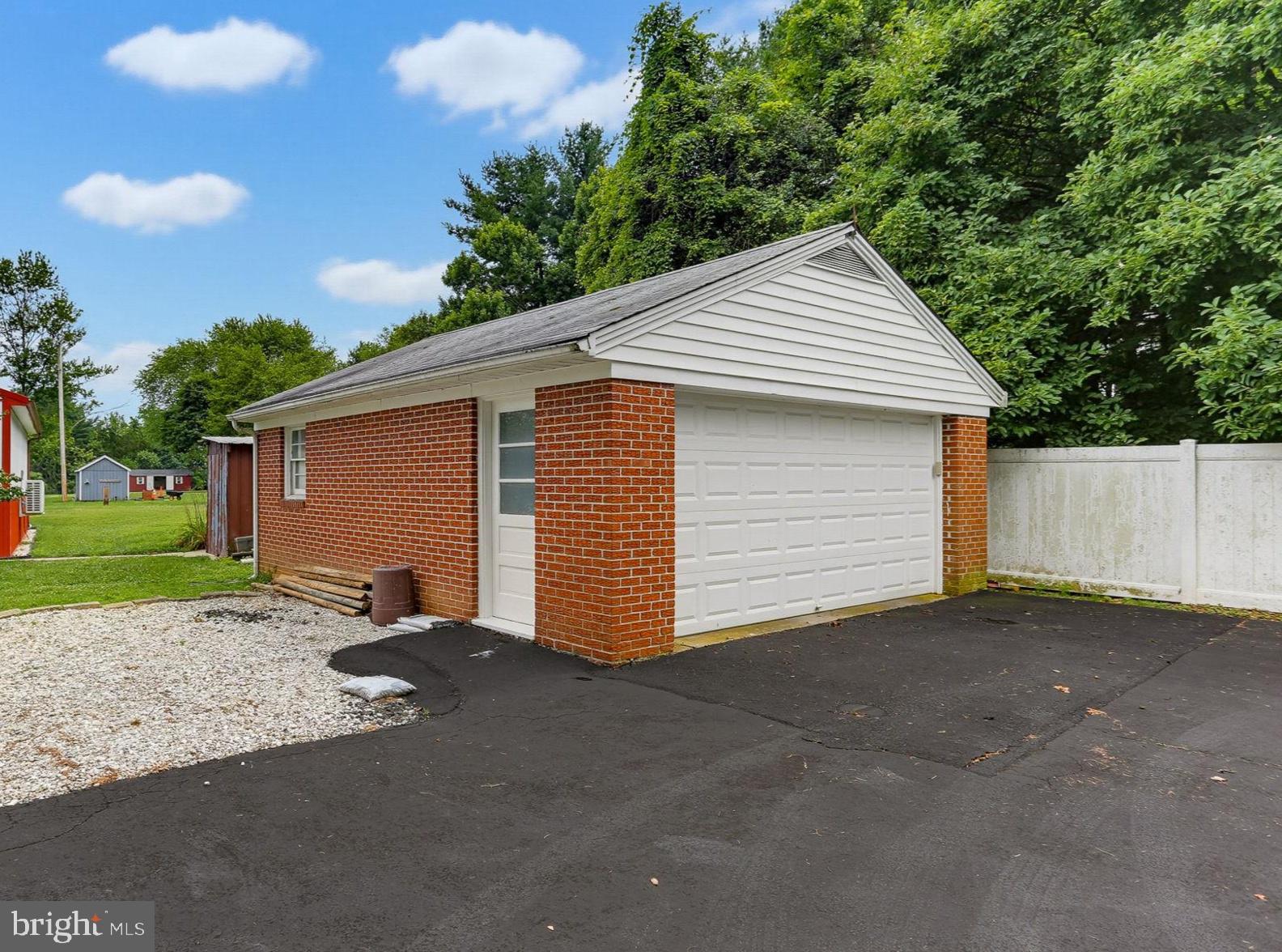 815 Reckord Road Fallston, MD 21047 - Photo 20 of 31 Charming garage with lush greenery backdrop.