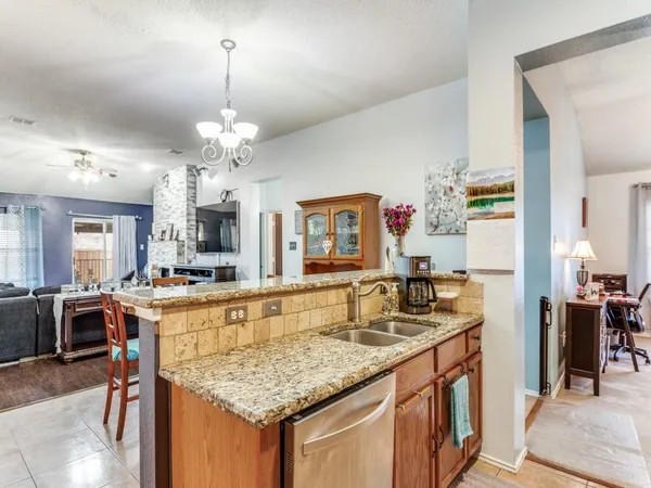 a kitchen with kitchen island granite countertop counter top space and stainless steel appliances