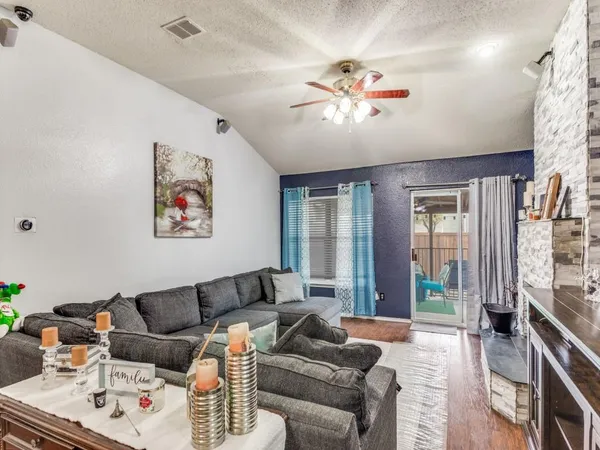 a living room with furniture and a chandelier