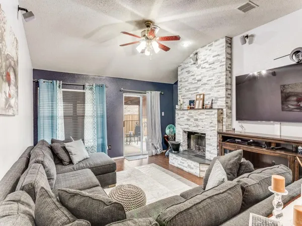 a living room with furniture fireplace and flat screen tv