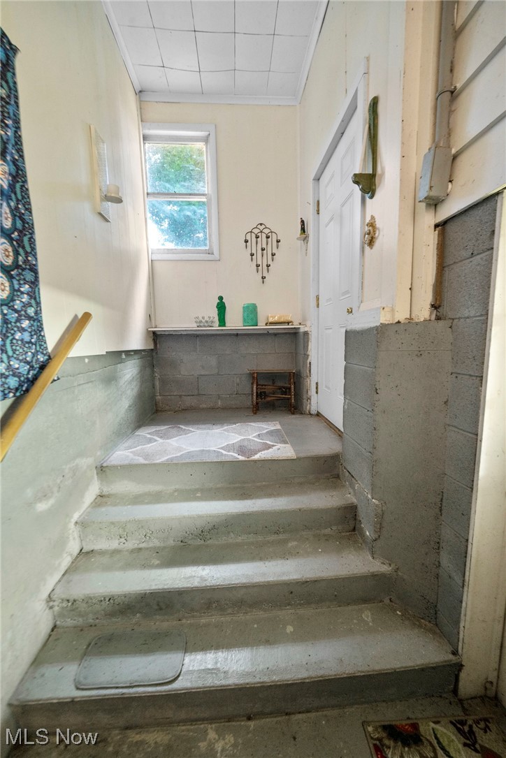 1090 Plymouth Ridge Road Ashtabula, OH 44004 - Photo 26 of 26 Stairs featuring crown molding