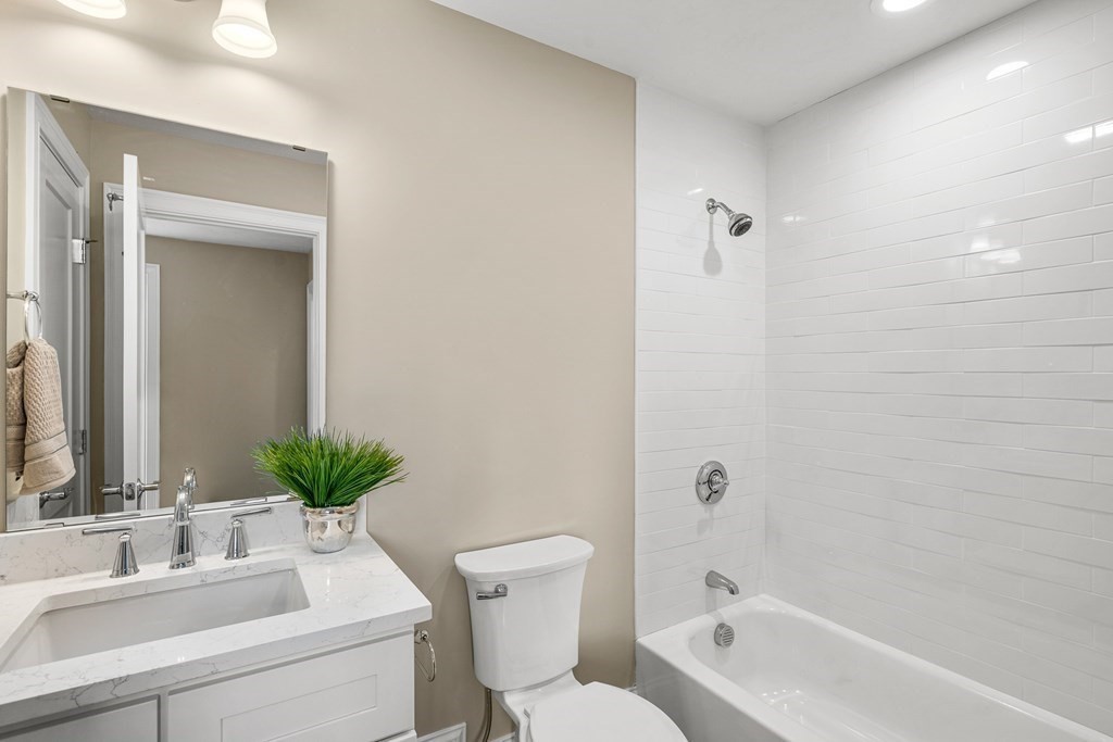 2 Audubon Way, Unit 2 Canton, MA 02021 - Photo 4 of 12 a bathroom with a sink a toilet a tub and mirror