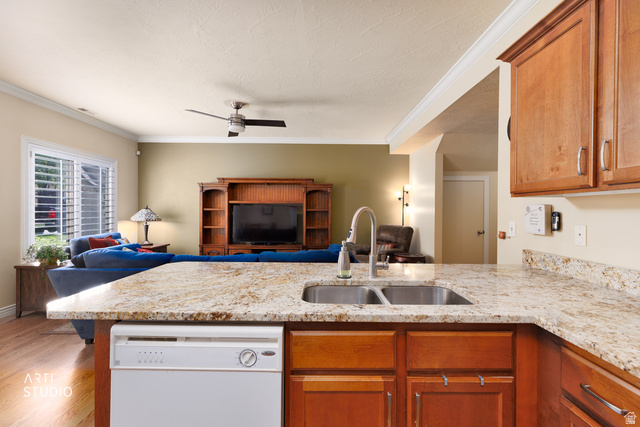 6761 950 East Midvale, UT 84047 - Photo 14 of 44 Kitchen island featuring granite countertops, a double basin stainless steel sink with a high-arc faucet, and integrated dishwasher