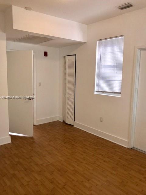 1000 Meridian Avenue, Unit 2 Miami Beach, FL 33139 - Photo 11 of 12 an empty room with wooden floor and closet