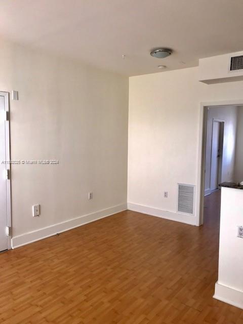 1000 Meridian Avenue, Unit 2 Miami Beach, FL 33139 - Photo 3 of 12 an empty room with wooden floor and cabinet