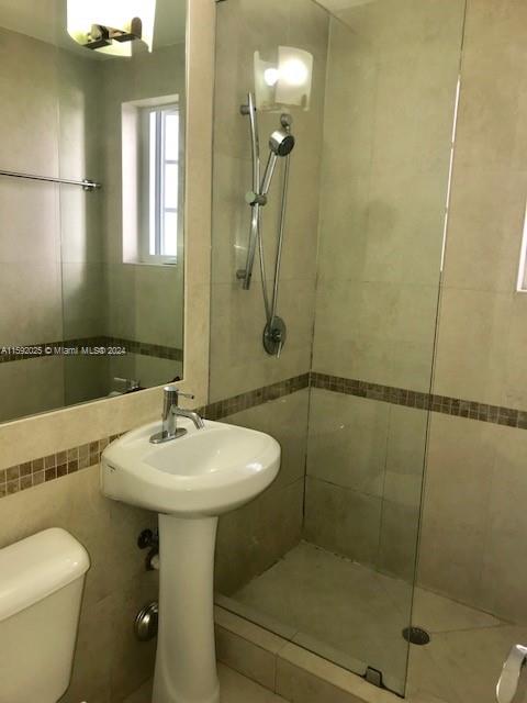 1000 Meridian Avenue, Unit 2 Miami Beach, FL 33139 - Photo 4 of 12 a bathroom with a sink toilet and shower