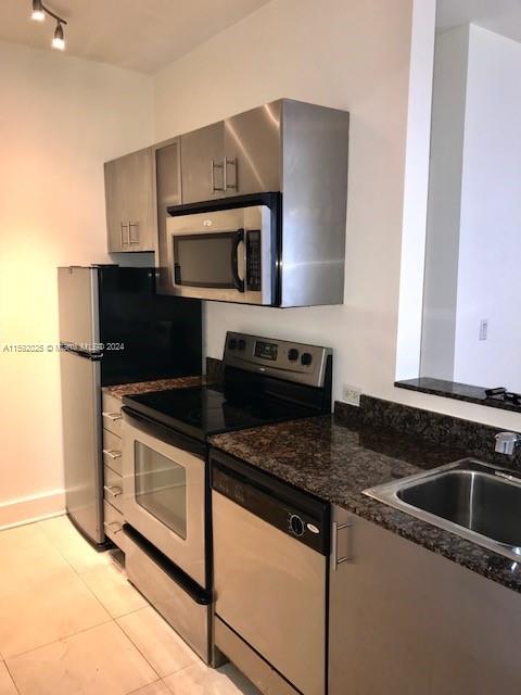 1000 Meridian Avenue, Unit 2 Miami Beach, FL 33139 - Photo 6 of 12 a kitchen with granite countertop a stove and a microwave