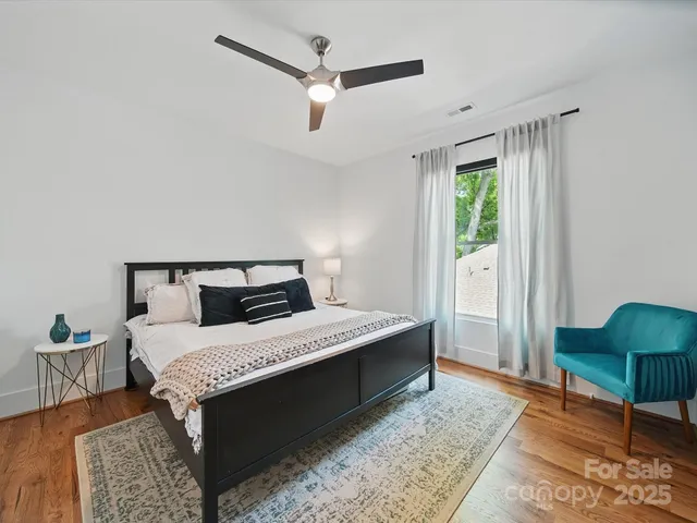 a bed sitting in a bedroom next to a window