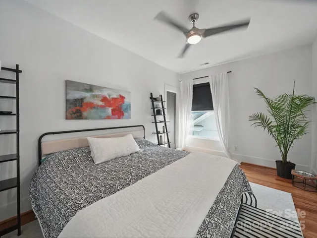 a bedroom with furniture and a large window