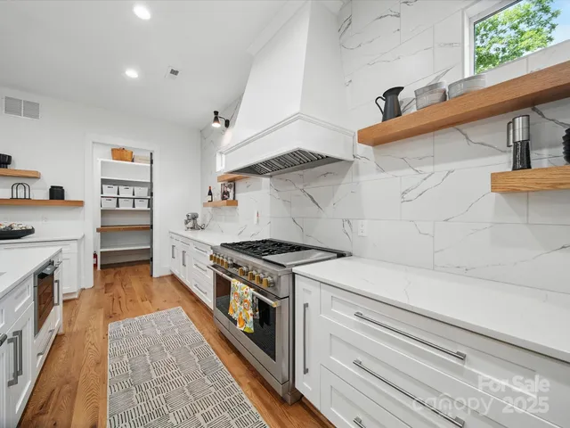 a kitchen with stainless steel appliances granite countertop a stove and a refrigerator