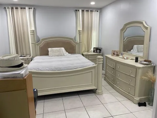 a bedroom with a bed and a dresser