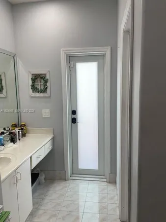 a view of a bathroom with a sink and mirror