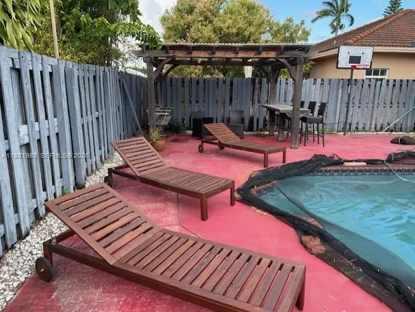 a view of outdoor sitting area with wooden fence