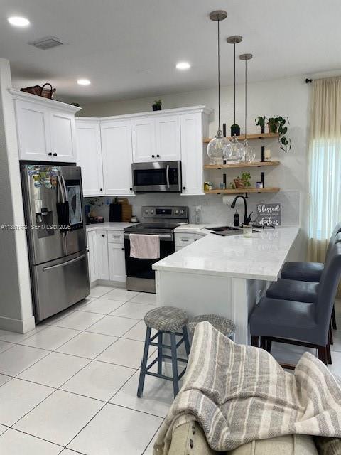 18214 Southwest 144th Place Miami, FL 33177 - Photo 8 of 20 a kitchen with stainless steel appliances kitchen island granite countertop a sink a stove a refrigerator cabinets and chairs
