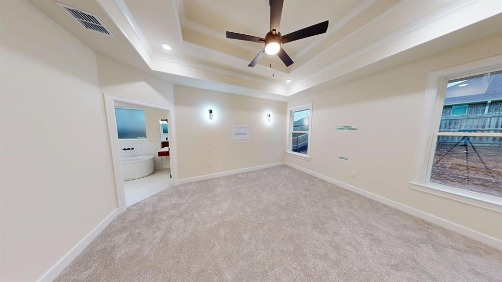 2509 Windmill Lane Longview, TX 75601 - Photo 7 of 35 Carpeted spare room with a raised ceiling, ceiling fan, and recessed lighting